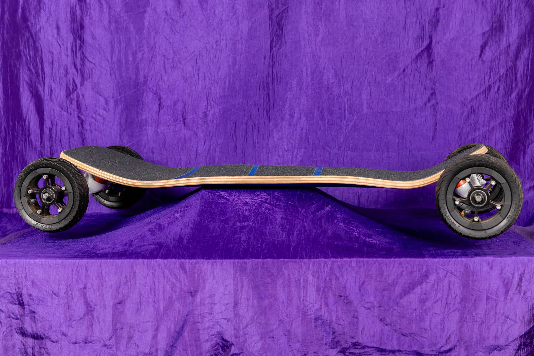Off-road skateboard on purple background.