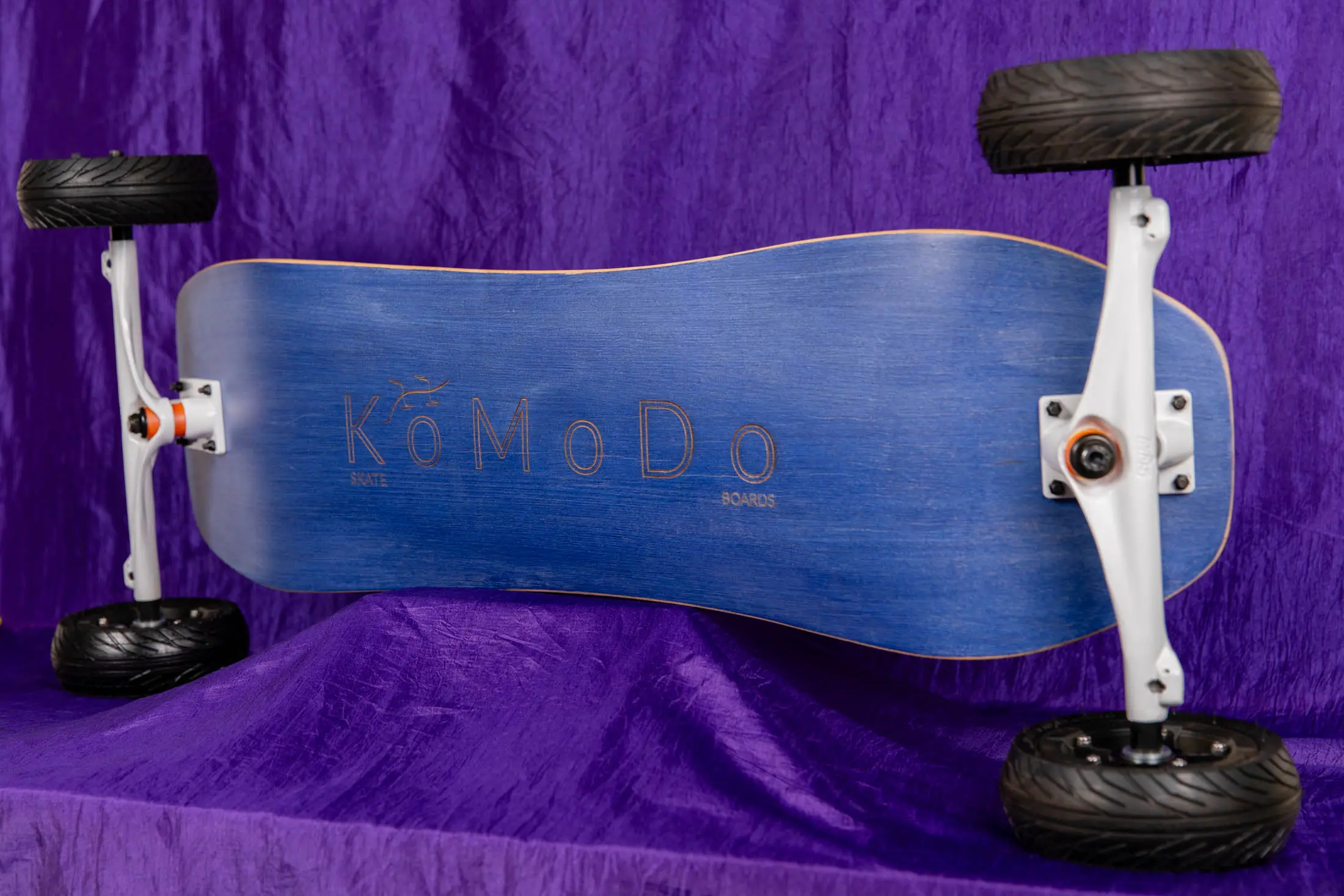 Blue skateboard with large wheels on display.