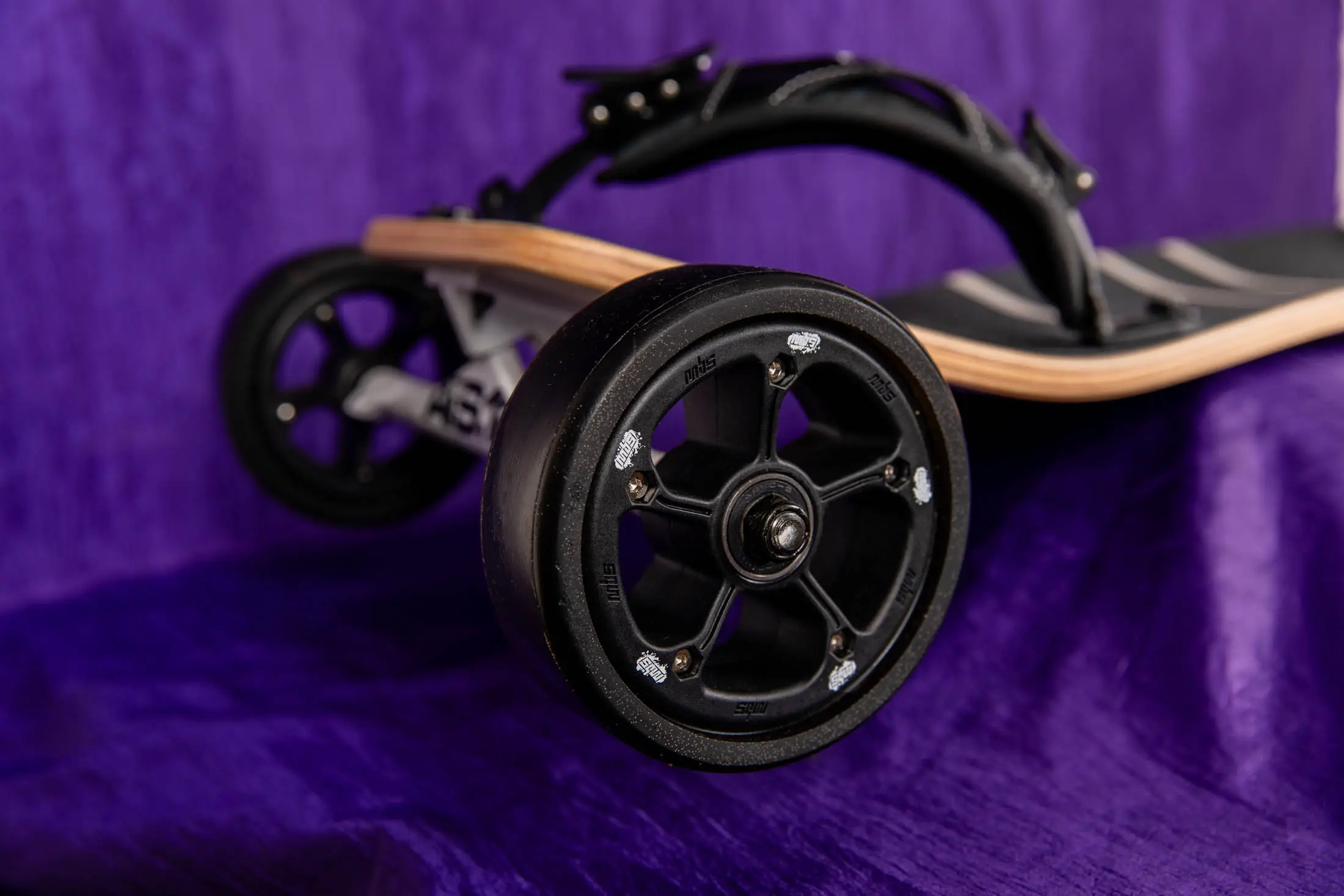 Off-road skateboard wheel on purple background.
