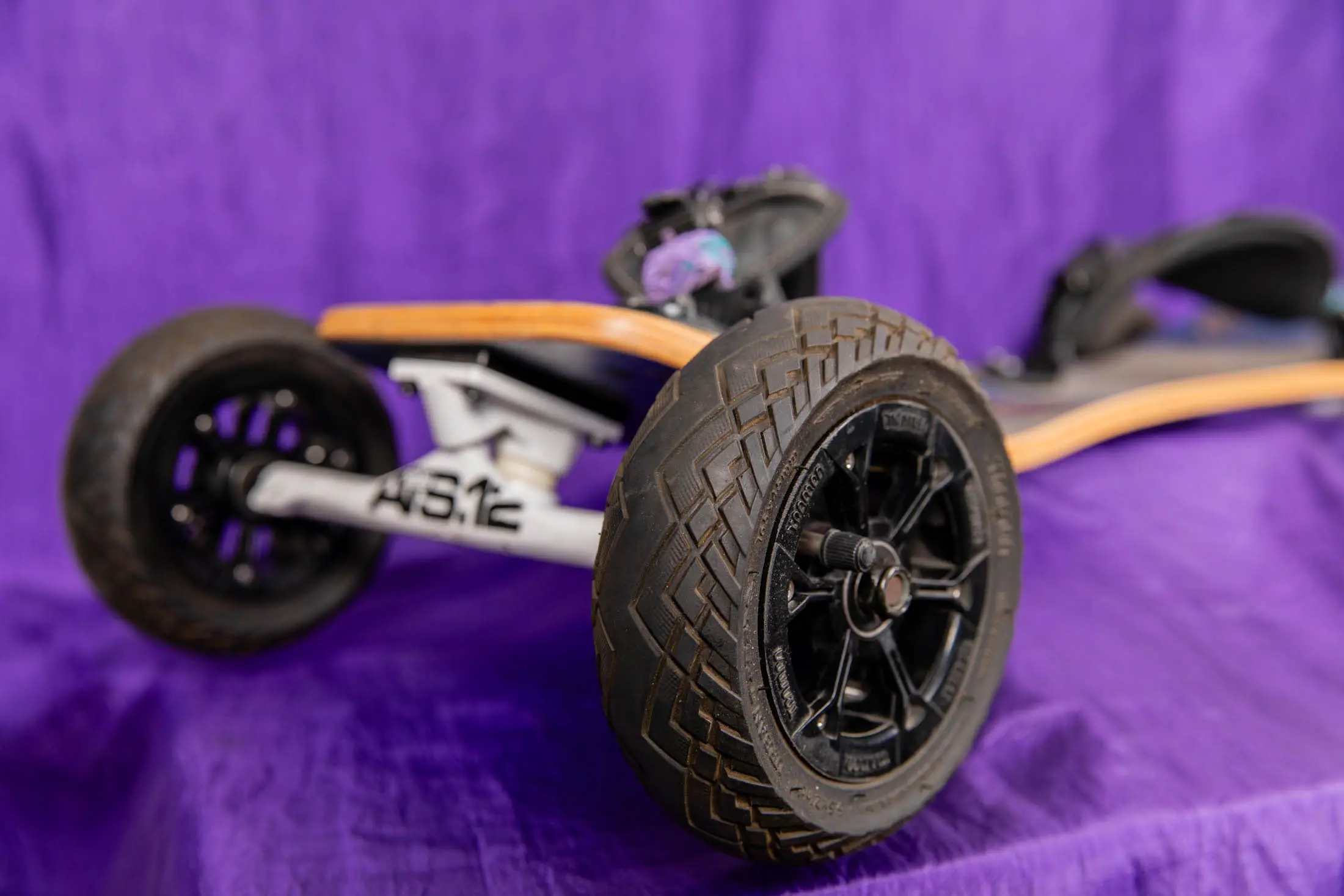 Off-road skateboard on purple background.