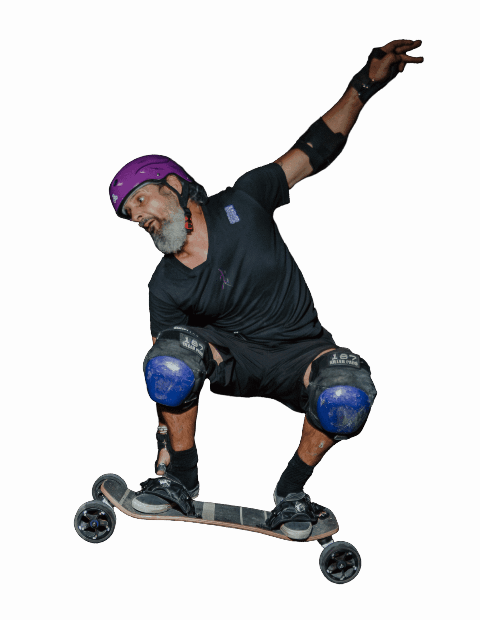 Man skateboarding with protective gear, black background.