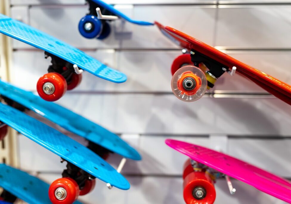 Colorful skateboards displayed on a wall rack.